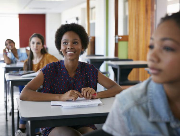 Young woman at desk looking attentively