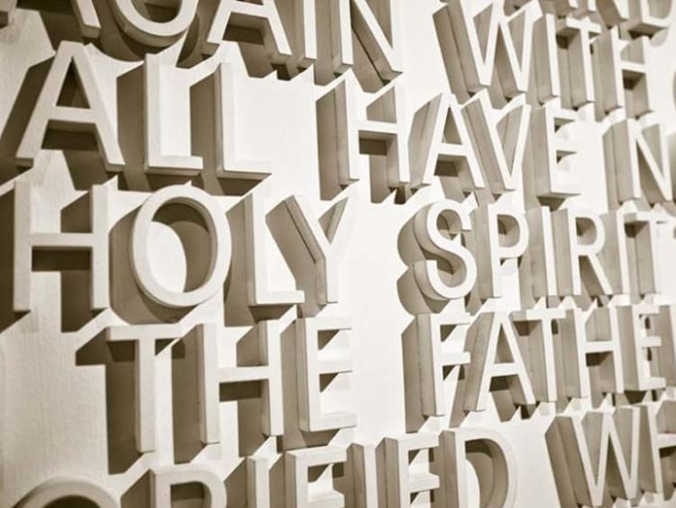 "holy spirit" written with white letters on a wall