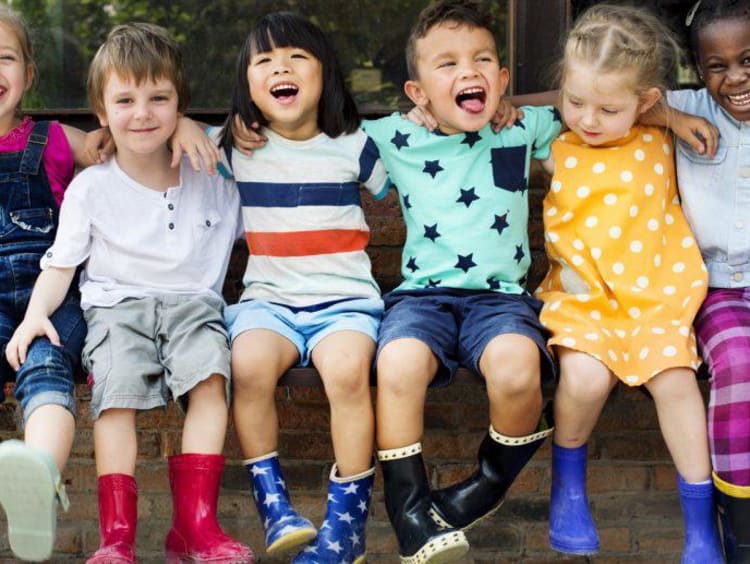 Children with their arms around eachother