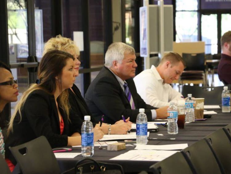 GCU faculty sitting at a long table