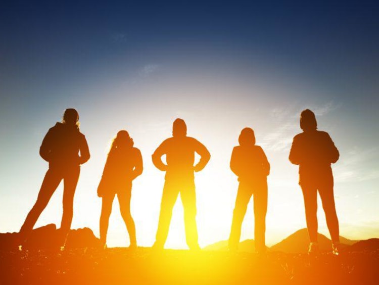people outside with sun behind them