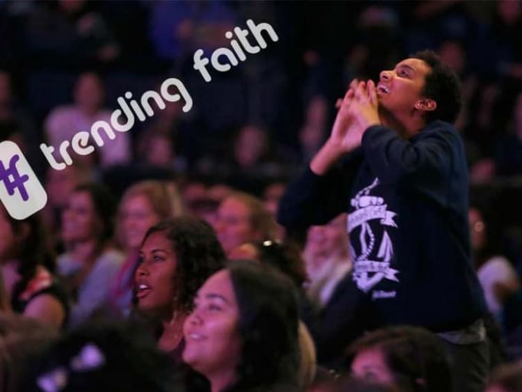 Female student worshiping during Chapel with hashtag trending faith