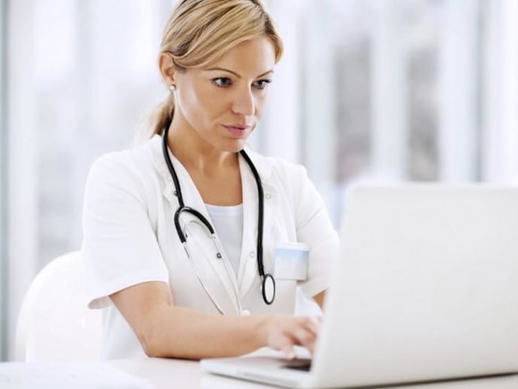 Young Adult looks at Laptop