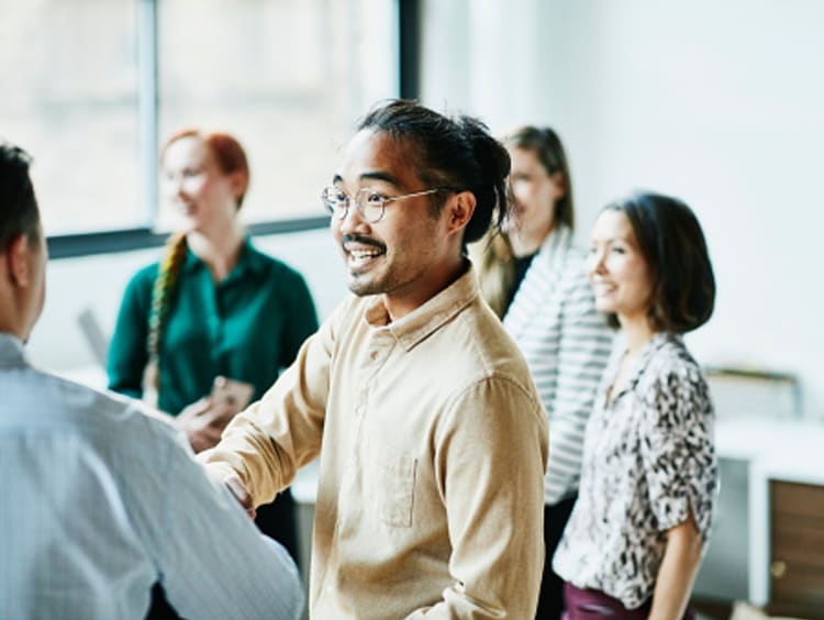 students and professionals networking in the workplace