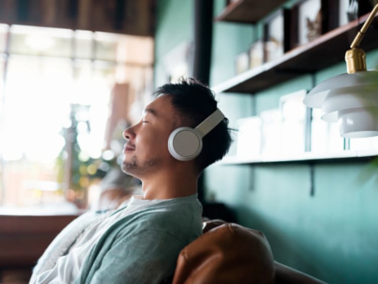 man improving spiritual health by listening to the Bible