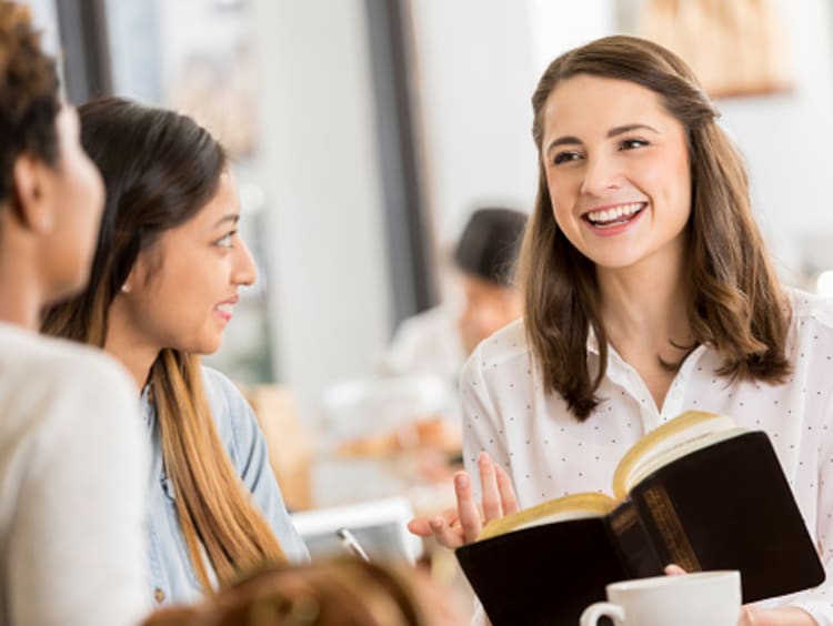 friends studying the Bible and discussing what is true happiness