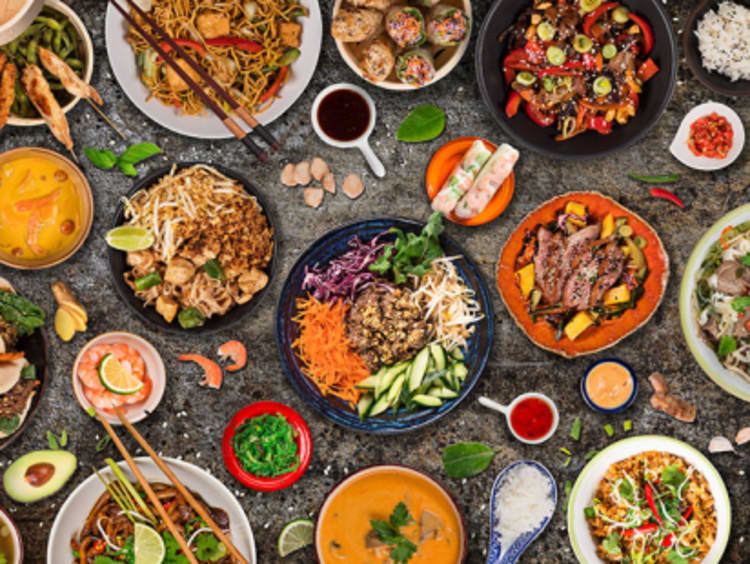 Table of plates featuring a variety of cuisine from other cultures