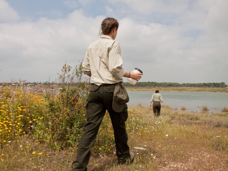 Two game wardens patrolling a river