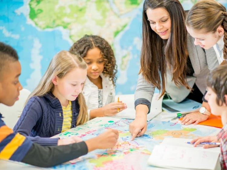 Woman teaching students geography