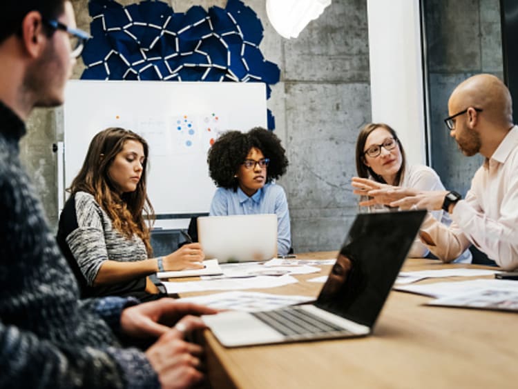 Male and female employee relations managers collaborating in office together