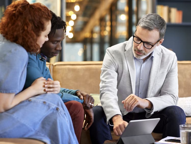 Investment manager helping young couple with their finances