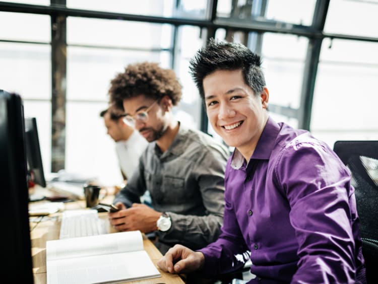Business professionals in office practicing conscious capitalism