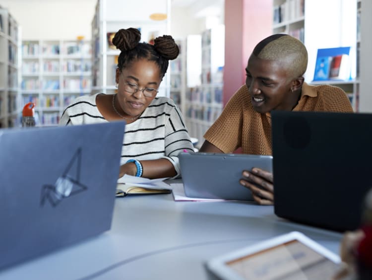 A group of EdD students studying in the library