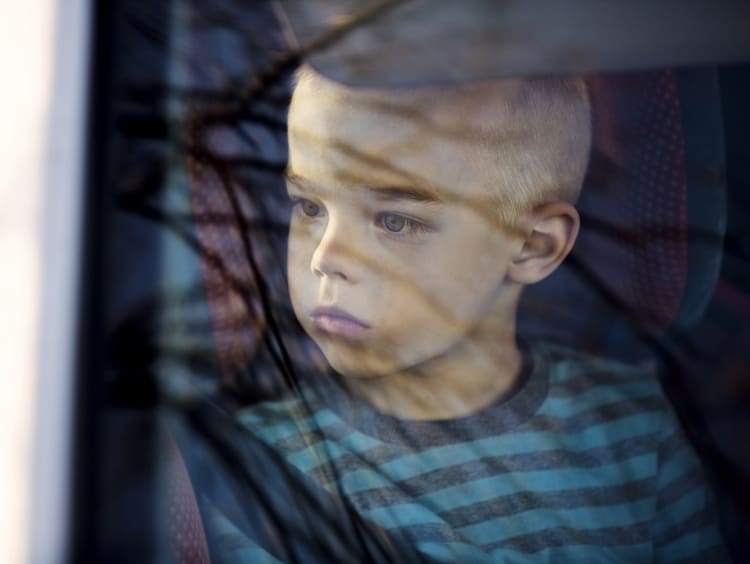 Student looking outside of car window