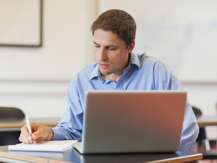 Male doctoral student working on his dissertation thesis