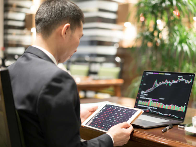 Business professional reviewing quantitative research at desk