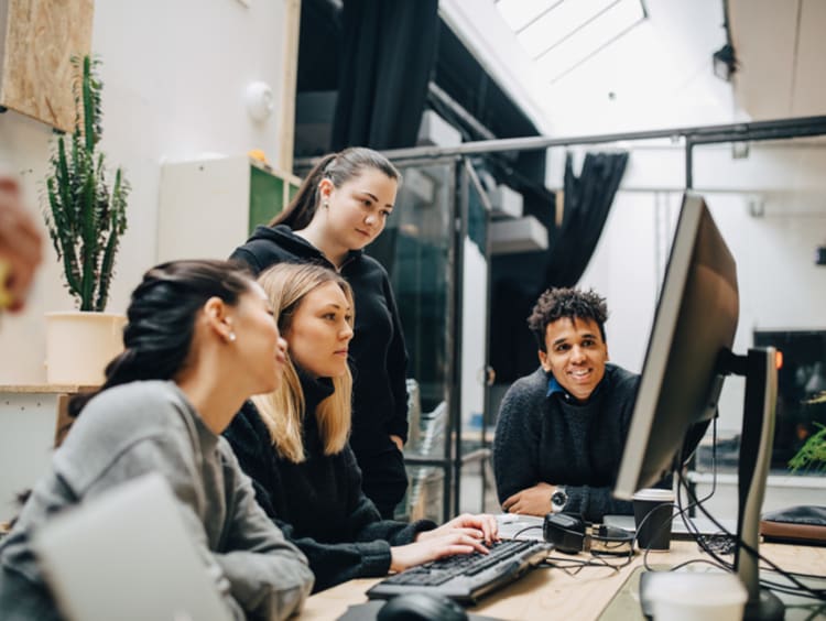 Colleagues discussing over computer