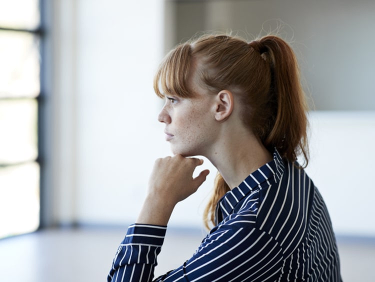 a young woman critical thinking about her college classes