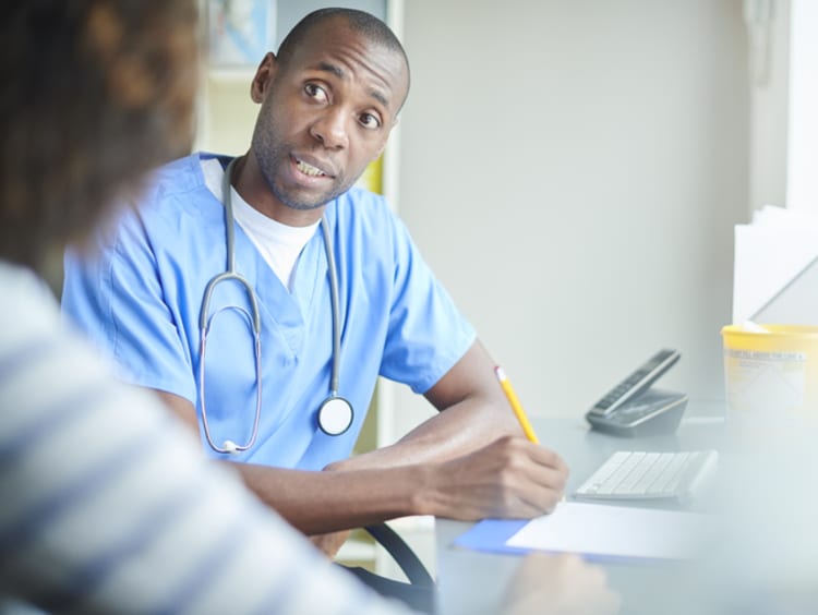 A male nurse talking with a patient
