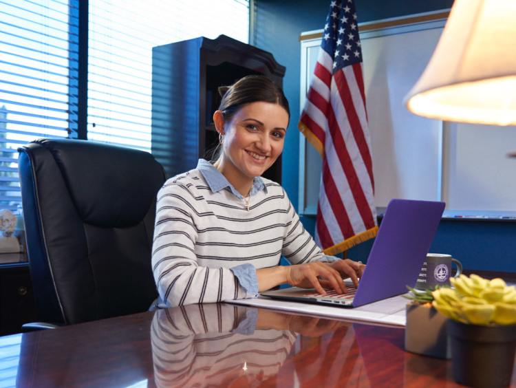 woman principle sits in office space