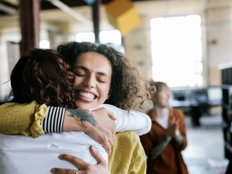 Friends embrace in a warm hug