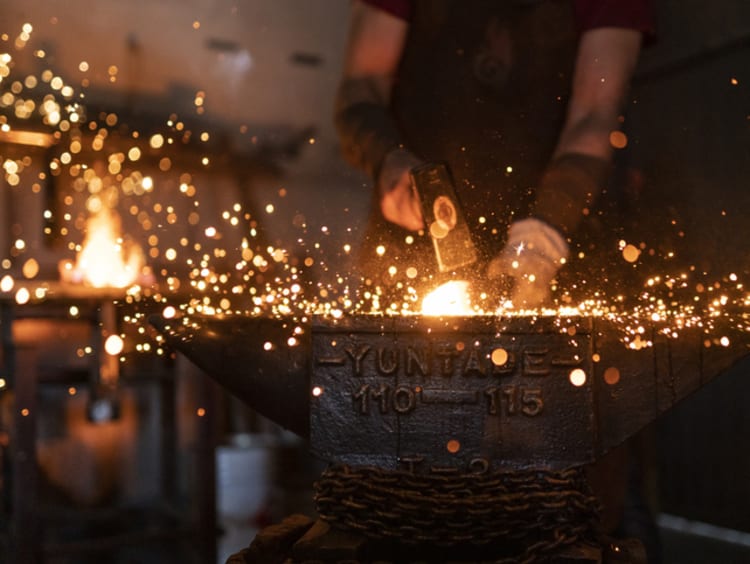 Man using his God given talents forging in his workshop