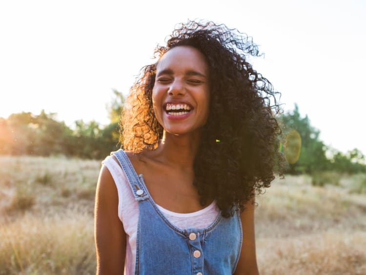 Woman enjoys a sunny day in an open field