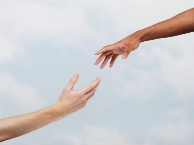 Two hands reaching out to help each other