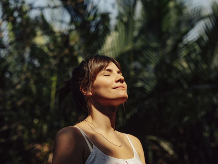 Woman standing up for Jesus and looking towards the sky