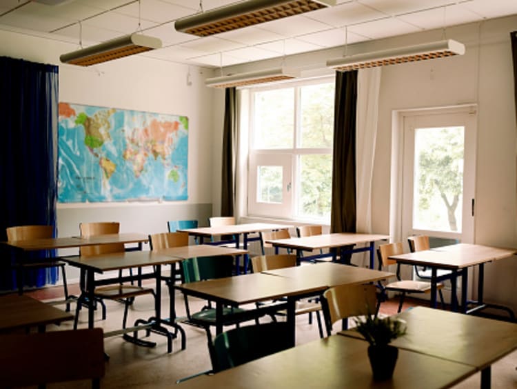 A classroom with desks and chairs