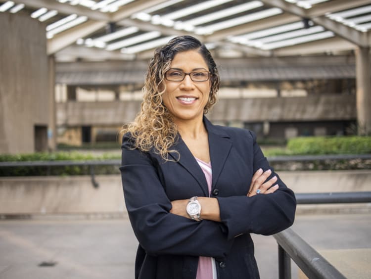 female school administrator smiling on school campus