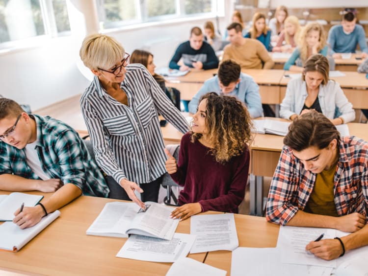 teacher helping students who have exceptional needs