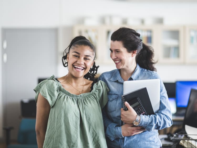A teacher and student laughing together