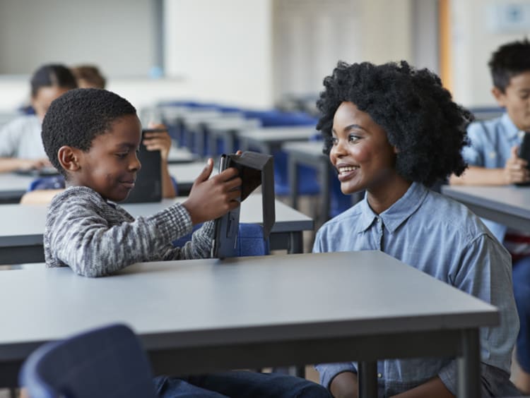 female teacher working with young student using social-emotional learning strategies