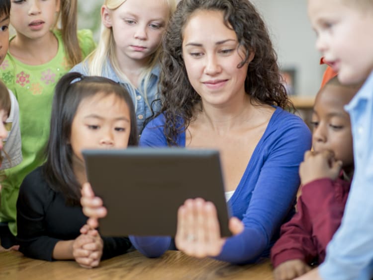 female teacher using game based learning techniques in classroom