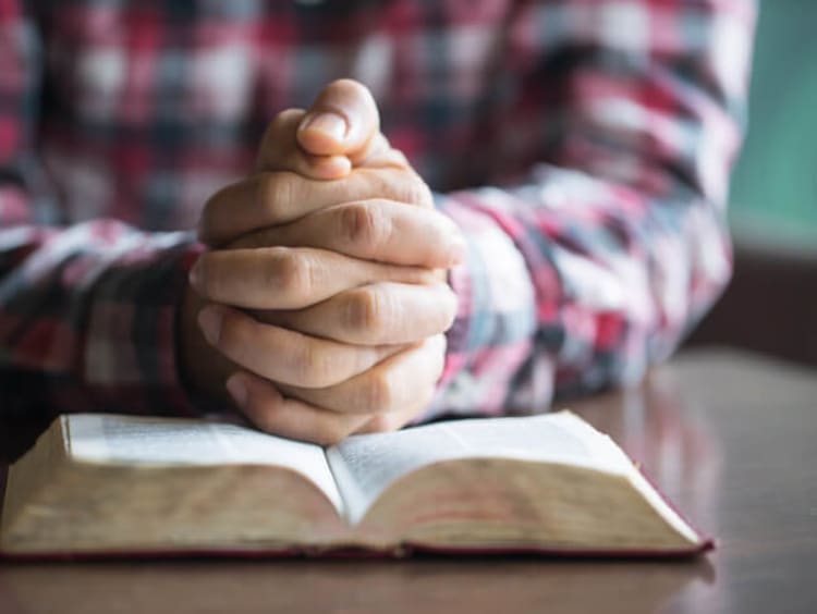 Man in plaid shirt meditates over a more excellent way passage in bible