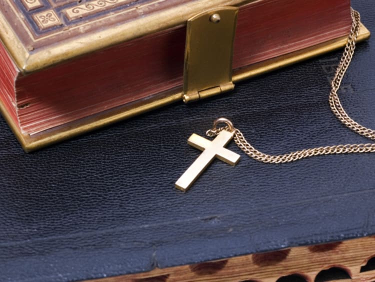 gold cross on bible