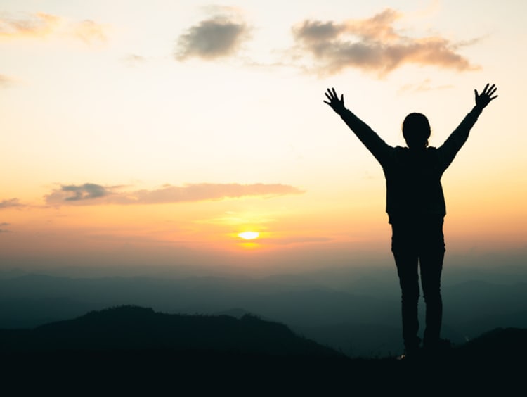woman praying on the mountain