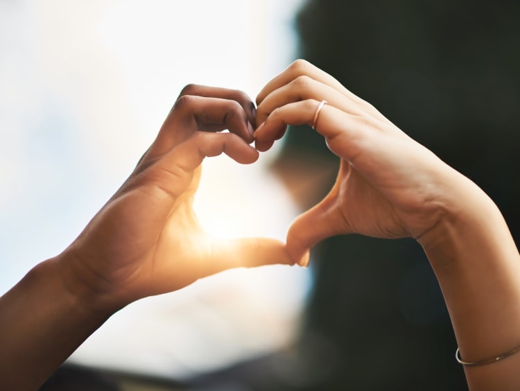 A pair of hands making a heart sign