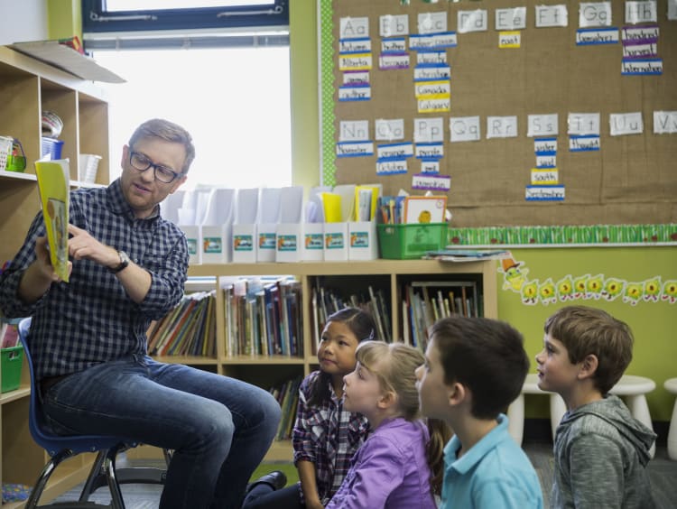 A teacher reading to his classroom