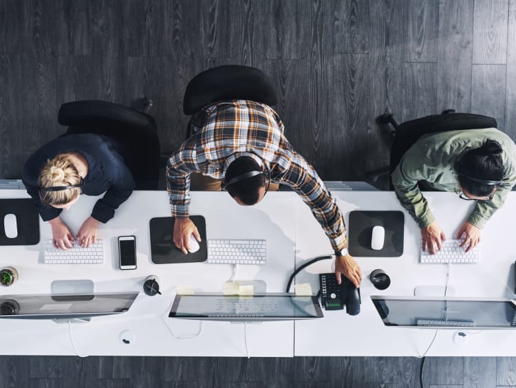 Men and women working on computers 