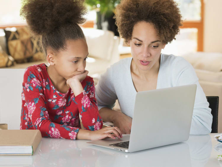 a mom helping her daughter with online homework