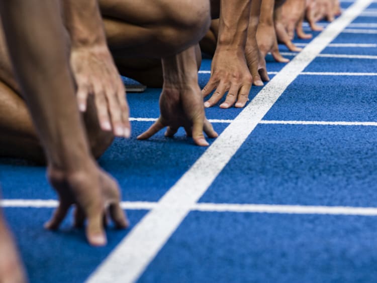 Athletes at the starting line of a racetrack