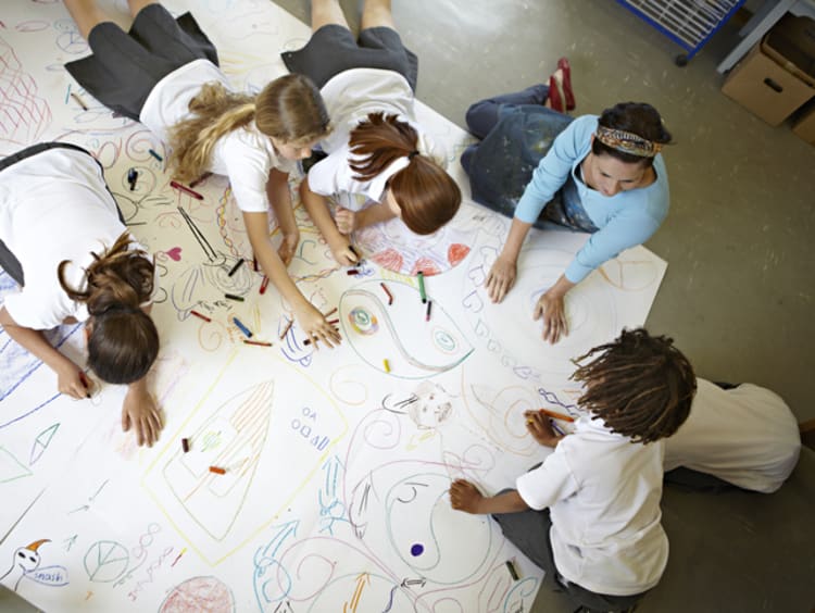 visual learners completing a large drawing together