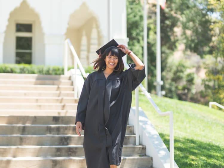 a college student on graduation day wearing a cap and gown