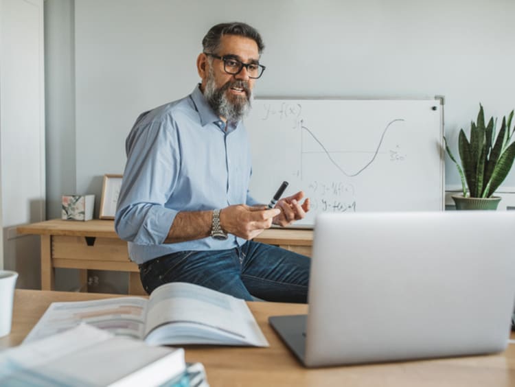 instructor teaching a lesson from home on a laptop