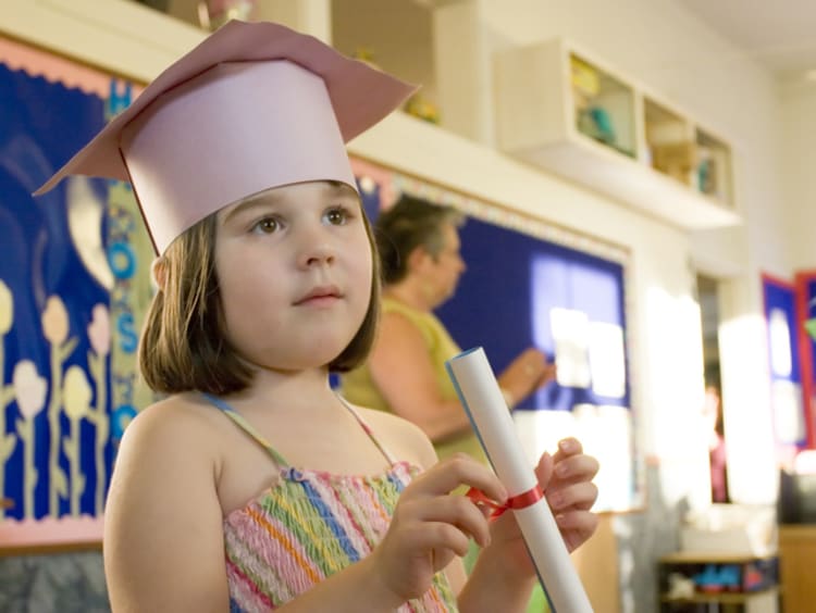 kindergarten graduate in paper cap