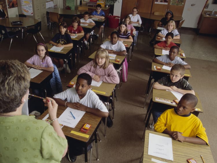 teacher instructing her students in the classroom