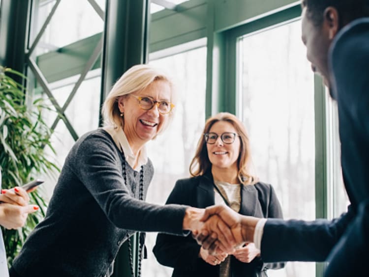 woman and man shaking hands