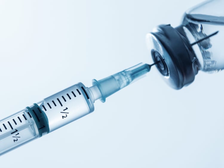 Hypodermic needle inside vaccine container